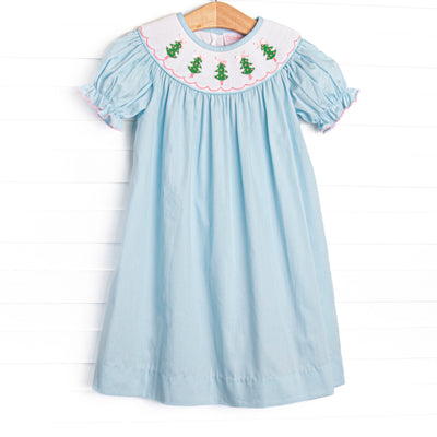 This dress features a aqua blue corduroy material, puff sleeves, and Christmas tree smockings