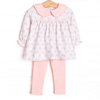 This set features rainbow patterned fabric, a pink Peter Pan collar, and long sleeves. Coordinating pink leggings to match.
