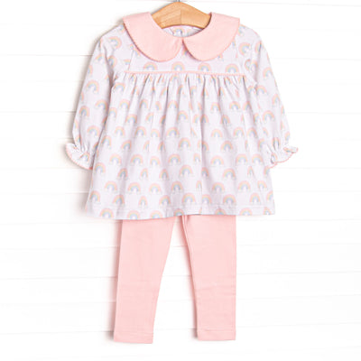 This set features rainbow patterned fabric, a pink Peter Pan collar, and long sleeves. Coordinating pink leggings to match.
