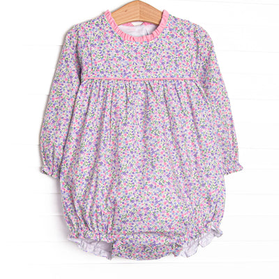  This bubble features purple floral fabric, pink piping and ruffle trim, and long sleeves. 