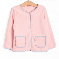 This coat features a pink fleece fabric, floral trim, and clear front buttons.