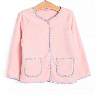 This coat features a pink fleece fabric, floral trim, and clear front buttons.