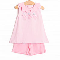This set features a pink striped print, pink scalloped collar, and trio of dinosaur appliques