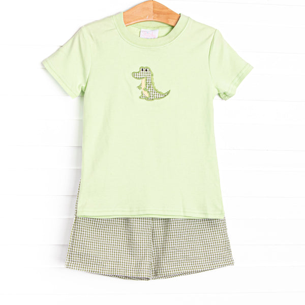  This set features a green top with a crocodile applique and coordinating green gingham shorts to match. 