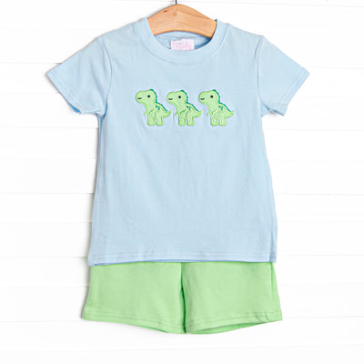  This set features a blue striped print, trio of dinosaur appliques, and green shorts to match. 