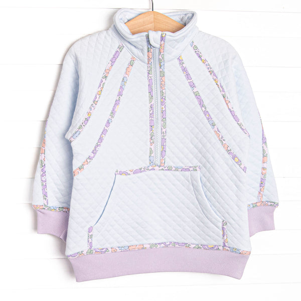 This pullover features blue fleece fabric, floral trim, and a half zip