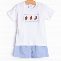 This set features short sleeve top with a trio of football smocking and blue mini gingham shorts to match.