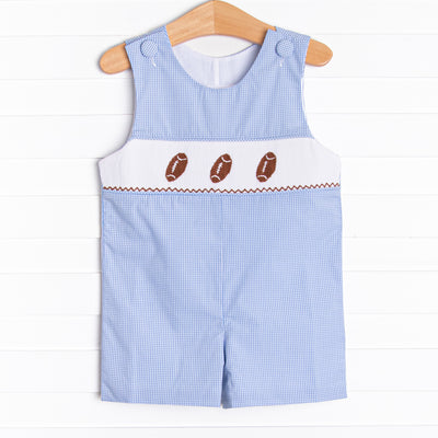 This&nbsp;Jon Jon&nbsp;features a blue mini gingham print, snaps on the stride, and a trio of football smocking.