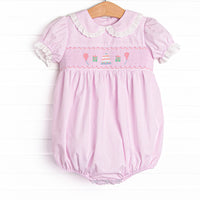  This bubble features a pink mini gingham print, puff sleeves with eyelet lace trim, and a birthday smocking. 