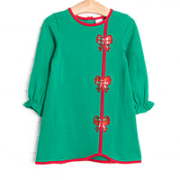  This dress features a green material, red trim, and bow appliques. 