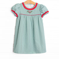  This dress features a green gingham print, red ruffle trim, and a holly embroidery. 