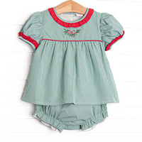  This set features a green gingham print, red ruffle trim, and a holly embroidery. 