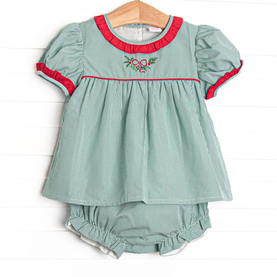  This set features a green gingham print, red ruffle trim, and a holly embroidery. 