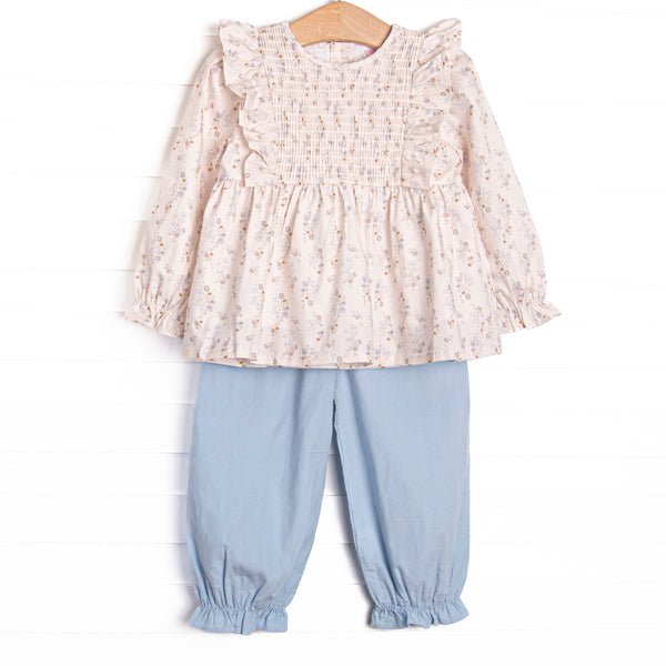 This set features a blue floral print, a dainty smocking, and flutter trim. Coordinating blue drawstring pants to match.