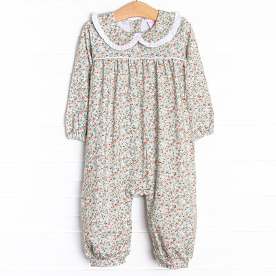  This romper features a green floral print, a peter pan collar with white ruffle trim, and snaps on the stride. 