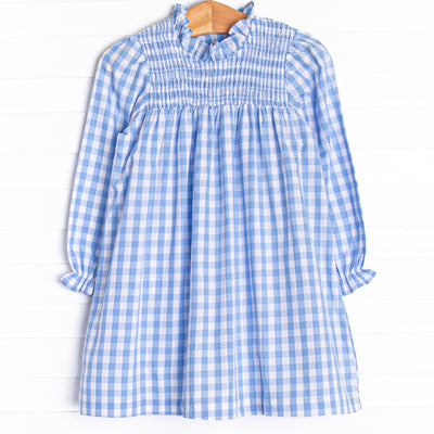  This dress features a smocking across the top of dress, a blue check print, and button closure on the back. 