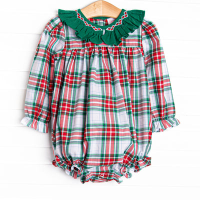 This bubble features a plaid print, a green ruffle collar and dainty smocking.