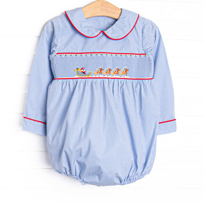  This bubble features a blue gingham print, peter pan collar, and a santa sleigh smocking.