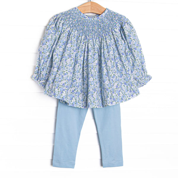  This set features a blue floral print, a dainty smocking, and blue leggings to match. 
