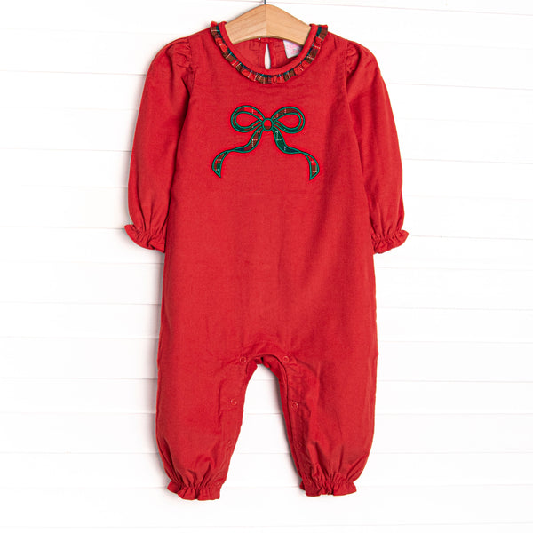 This romper features a red corduroy material, green bow applique, and plaid collar. 