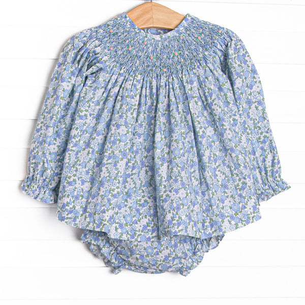 This set features a blue floral print, a dainty smocking, and blue diaper cover to match.