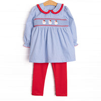  This set features a blue mini gingham print, red ruffle trim peter pan collar and a Santa Claus smocking. 