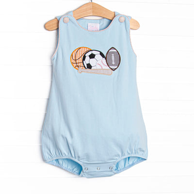 This bubble features blue knit material, snaps on the stride, and a variety of sports ball appliques.