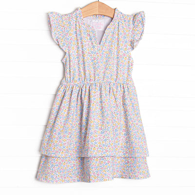 This dress features a yellow floral print, flutter sleeves, and a bow sash in the back.