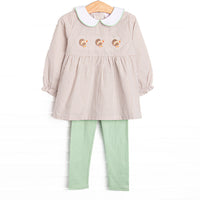 This dress features tan gingham material, a turkey embroidered design, a fun trimmed collar, and sage leggings to match.