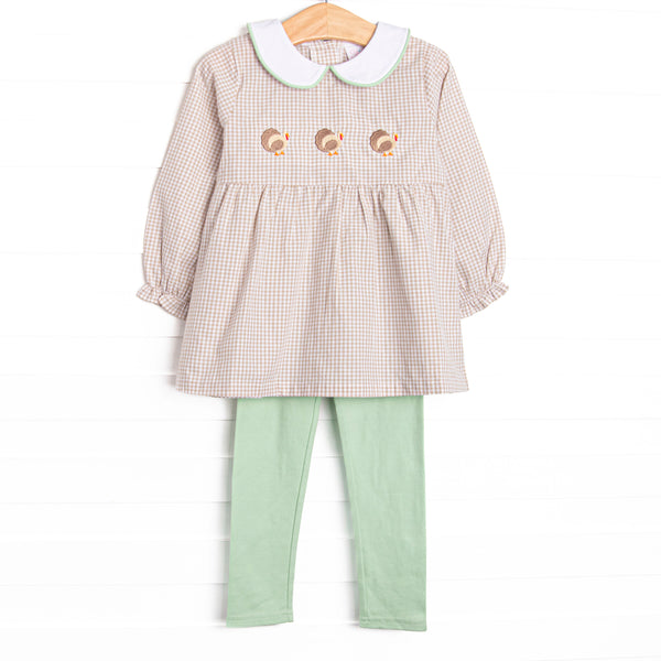 This dress features tan gingham material, a turkey embroidered design, a fun trimmed collar, and sage leggings to match.