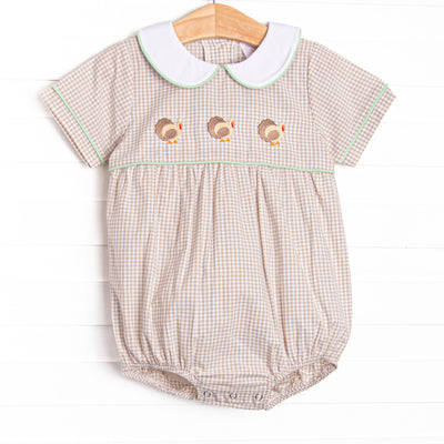  This bubble features tan gingham material, a turkey embroidered design, and a fun trimmed collar. 
