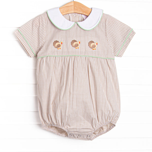  This bubble features tan gingham material, a turkey embroidered design, and a fun trimmed collar. 