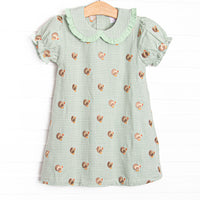This dress features sage gingham material, a turkey embroidered design, and a fun trimmed collar.
