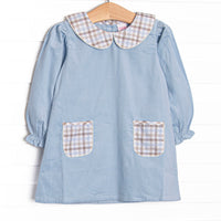 This dress features blue corduroy fabric, plaid front pockets, and a plaid Peter Pan collar.