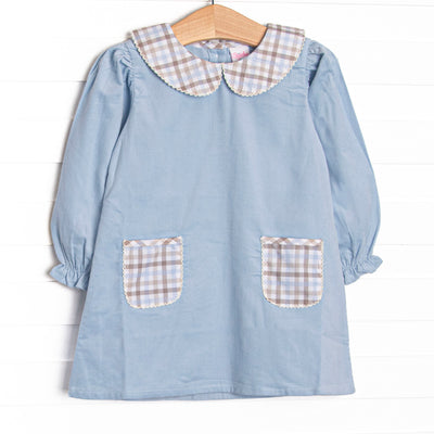 This dress features blue corduroy fabric, plaid front pockets, and a plaid Peter Pan collar.