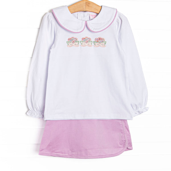 This set features white knit fabric, floral appliques, and a white Peter Pan collar. Coordinating purple corduroy skirt to match.