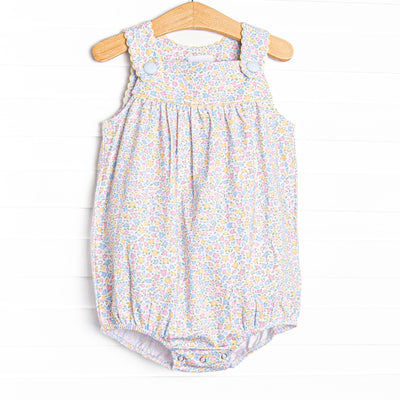 This bubble features a yellow floral print, front buttons, and snaps on the stride.