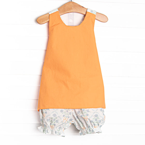 This set features a orange top with a criss cross back straps and floral bloomer shorts to match.