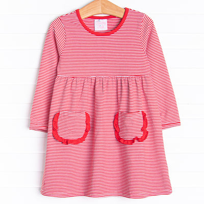  The dress features front ruffle pockets, red&nbsp;trim, and&nbsp;red stripes. 