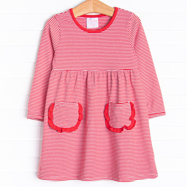  The dress features front ruffle pockets, red&nbsp;trim, and&nbsp;red stripes. 