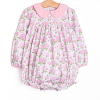 This bubble features a pink hydrangea print, a pink Peter Pan collar, and snaps on the stride.
