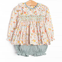 This set features green floral fabric, chest smocking, and a scalloped collar. Coordinating green bloomer shorts to match.