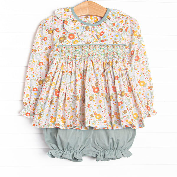 This set features green floral fabric, chest smocking, and a scalloped collar. Coordinating green bloomer shorts to match.