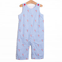  This Jon Jon features a blue gingham print, front covered buttons, and candy cane embroideries. 