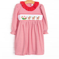 This dress features a red striped print, a red ruffle collar, and a smocking of Santa's Sleigh.