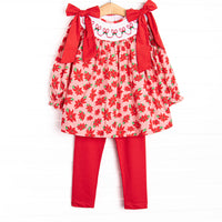 This set features a poinsettia print, holly smocking, and big red corduroy bows on the shoulders.