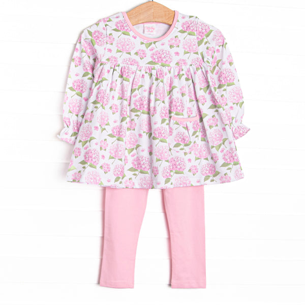 This set features a long sleeve top in a pink hydrangea print, pink trim, and a front pocket. Coordinating pink knit leggings to match.