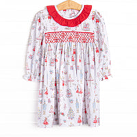 This dress features a Christmas print, dainty smocking, and red ruffle collar.