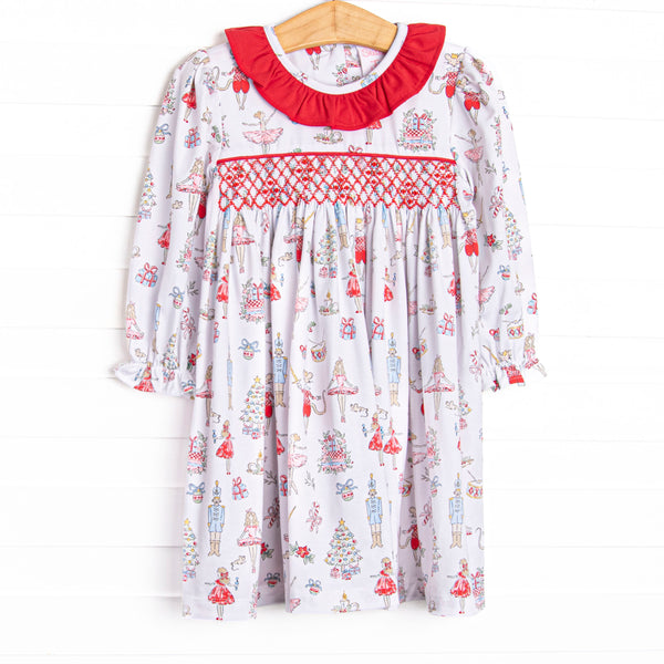 This dress features a Christmas print, dainty smocking, and red ruffle collar.