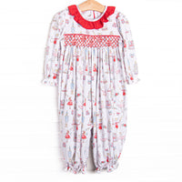 This romper features a Christmas print, dainty smocking, and red ruffle collar.